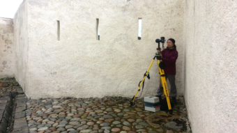 Person taking a photograph in an old building