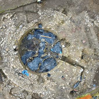 Aerial view of a dig site with a circular stone structure