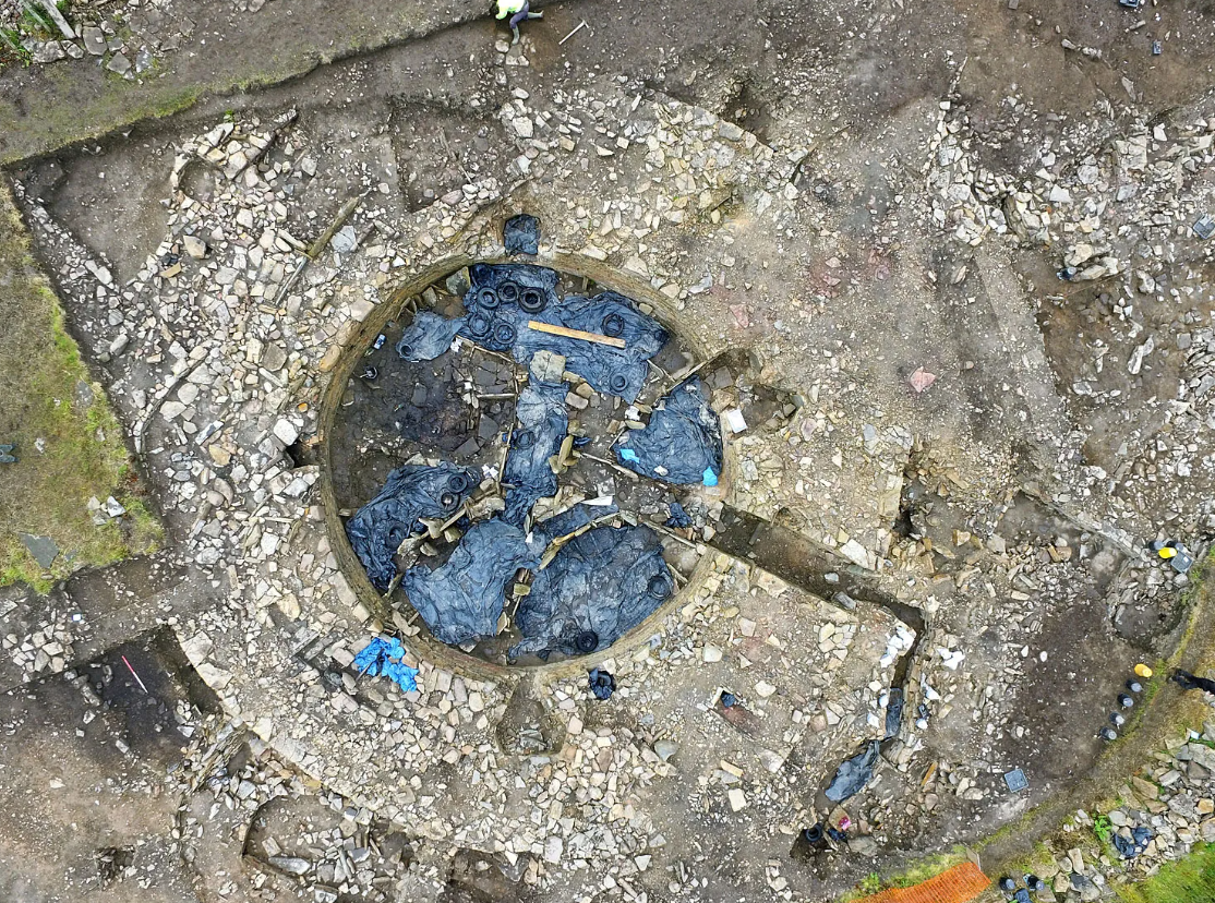 Aerial view of a dig site with a circular stone structure