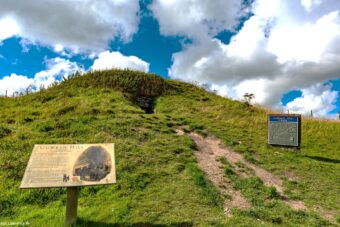 Photo of the exterior of a chambered cairn covered in turf