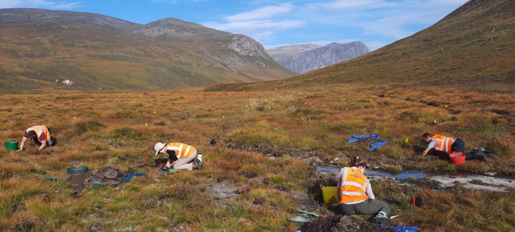 People excavating in mountainous area