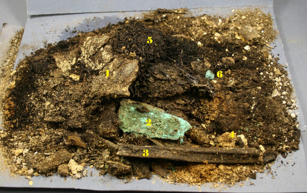 Material from the Forteviot cist during post-ex analysis including a small knife, elements of a fire-making kit and fragments of a leather bag © GUARD Archaeology