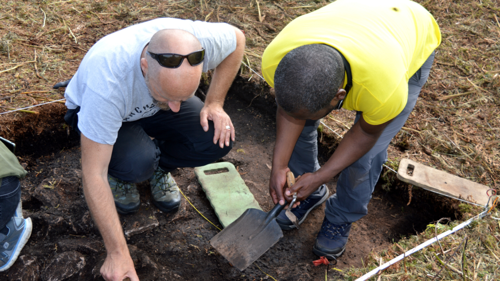 Two people in an archaeological trench