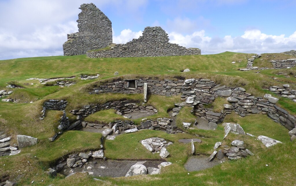 Stone ruins - some excavated with a stone structure in the background