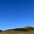 Photo of a hill under a clear blue sky