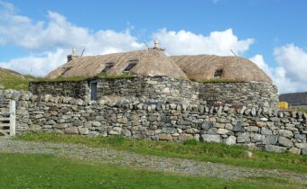 Photo of two long stone-built blackhouses