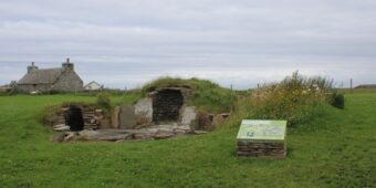 Photo of a reconstructed prehistoric settlement mound