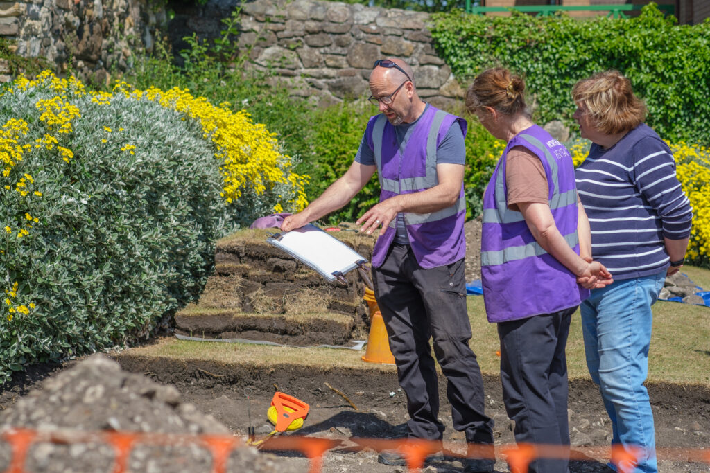 Three people taking part in the Inverkeithing Friary excavation
