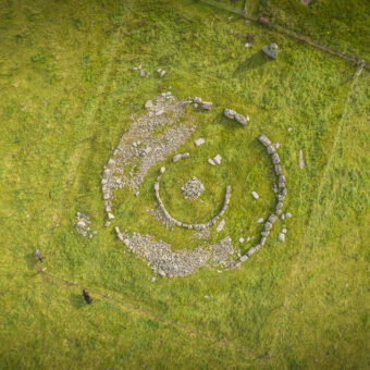Aerial photo of a stone ring cairn in a field