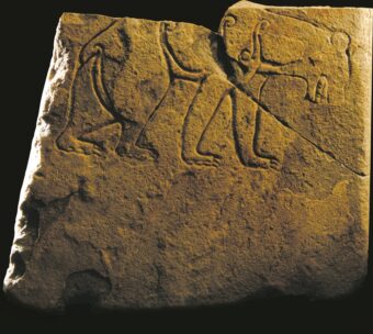 Photo of a carved stone featuring a prowling bear