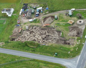 Aerial photo of an archaeological dig revealing a prehistoric stone settlement