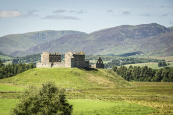 Landscape photo of a ruined stone military barracks on a hill