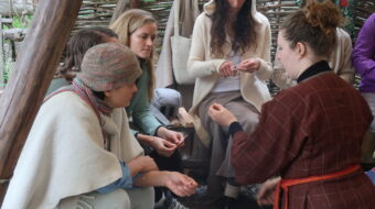 Several people taking part in an activity in a wooden structure