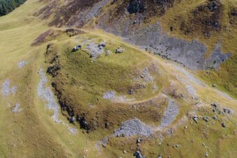Aerial photograph of the remains of a hillfort in a moorland landscape