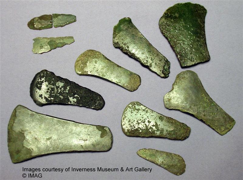 Photo of a collection of bronze axeheads and daggers