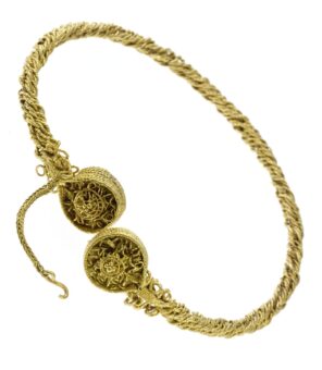 A twisted gold neck ring with circular terminals