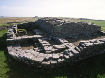 Photo of the low, stone remains of a medieval castle, taken from the old entrance