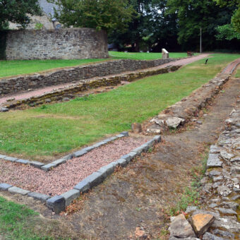 Photo of the stone foundations of a Roman fort in a churchyard