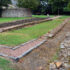Photo of the stone foundations of a Roman fort in a churchyard
