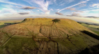 Photo of a large flat-topped hill in the sun