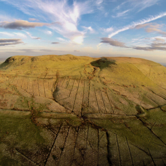 Photo of a large flat-topped hill in the sun