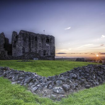 Ruined castle with sun setting in the background