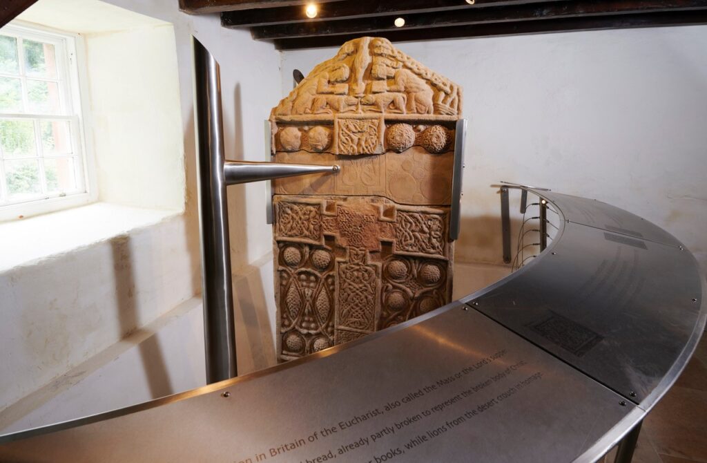 A carved stone with an elaborately decorated cross in high relief