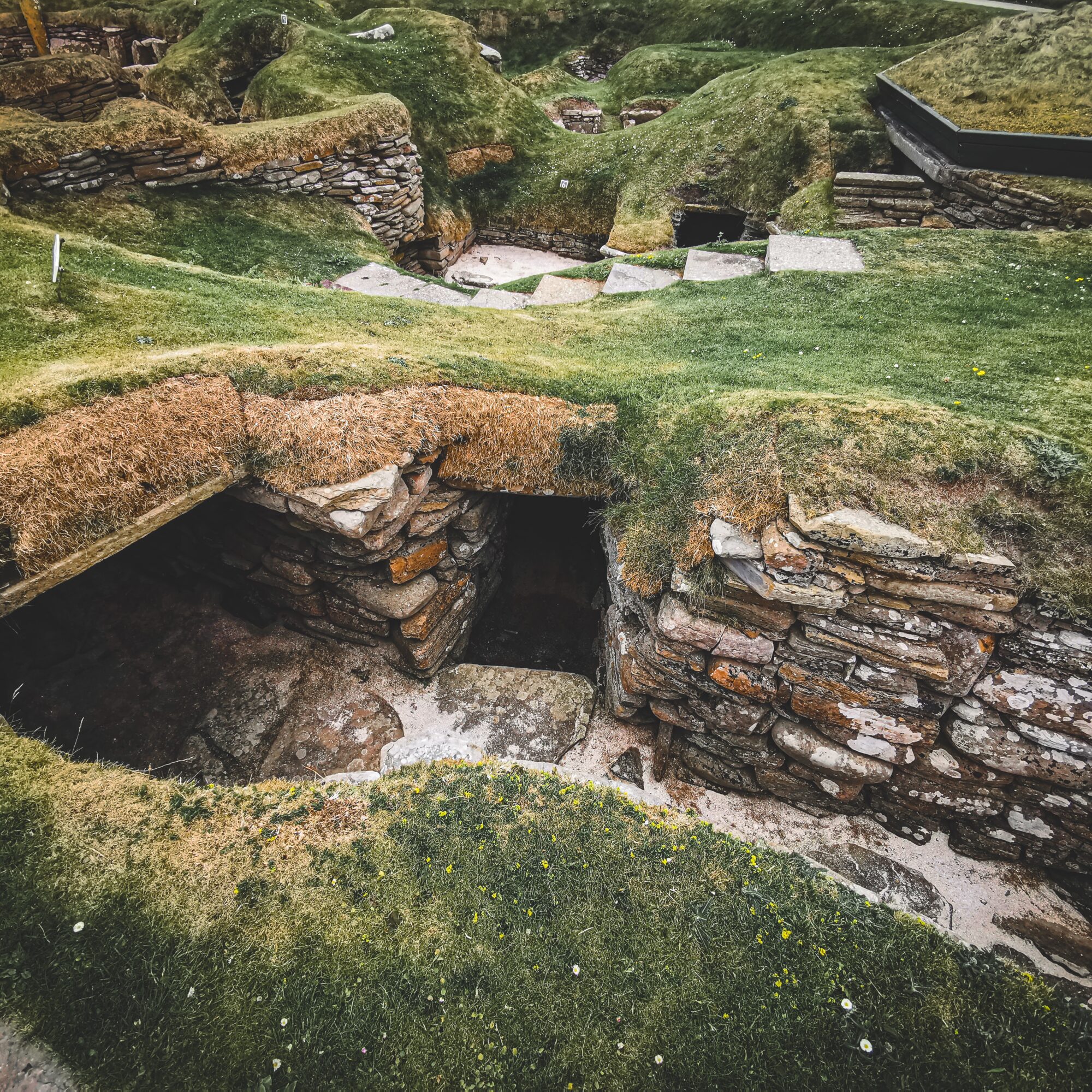 Excavated stone room with turf on top