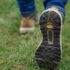 Photo of boots as person is walking - wearing jeans. Walking on grass.