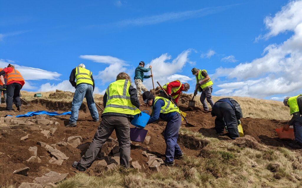 Why should I volunteer at an archaeological dig in Scotland?