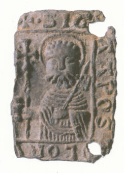 Photo of half a metal pilgrim's badge showing St Peter and the keys to heaven