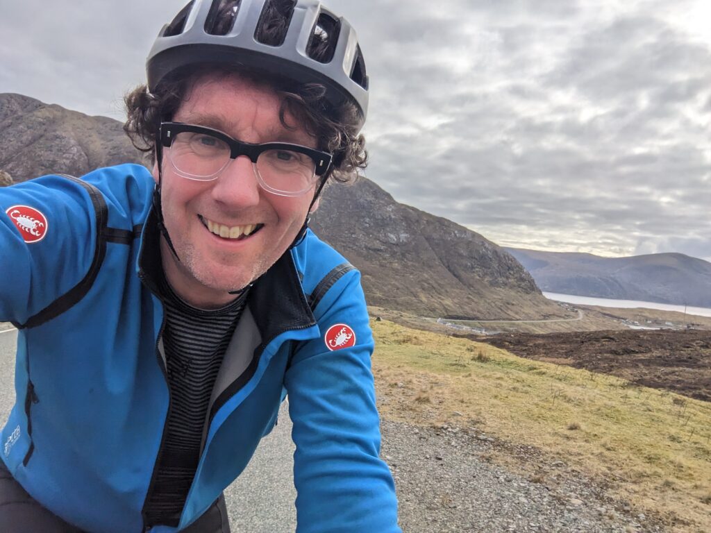 Person taking a selfie wearing a cycling helmet and glasses