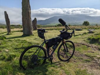 Bike beside large stones in a rural landscape