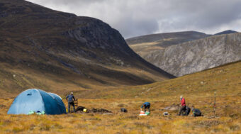 Archaeological dig taking place in a mountainous landscape
