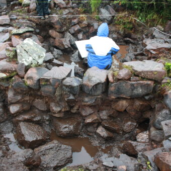 Excavations underway on the artificial islet settlement in Loch na Claise, with Historic Assynt
