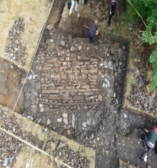 Aerial view of a stone structure being excavated