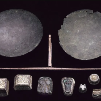 Photo of a set of medieval metal weights and a scale