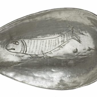 Bowl of a silver spoon with a fish engraved inside