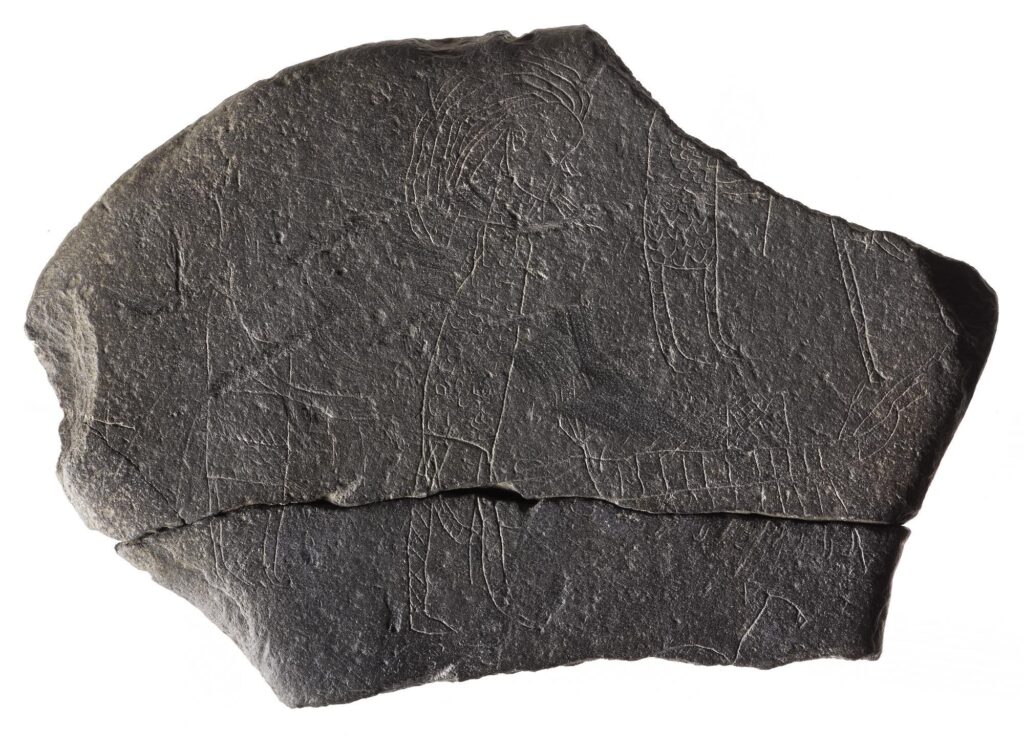 ‘The Hostage stone’ depicts a scene, either witnessed or imagined, that shows “wild-haired raiders” dressed in long coats of mail dragging a hunched figure by a rope, towards a ship. This prisoner may be a monk 