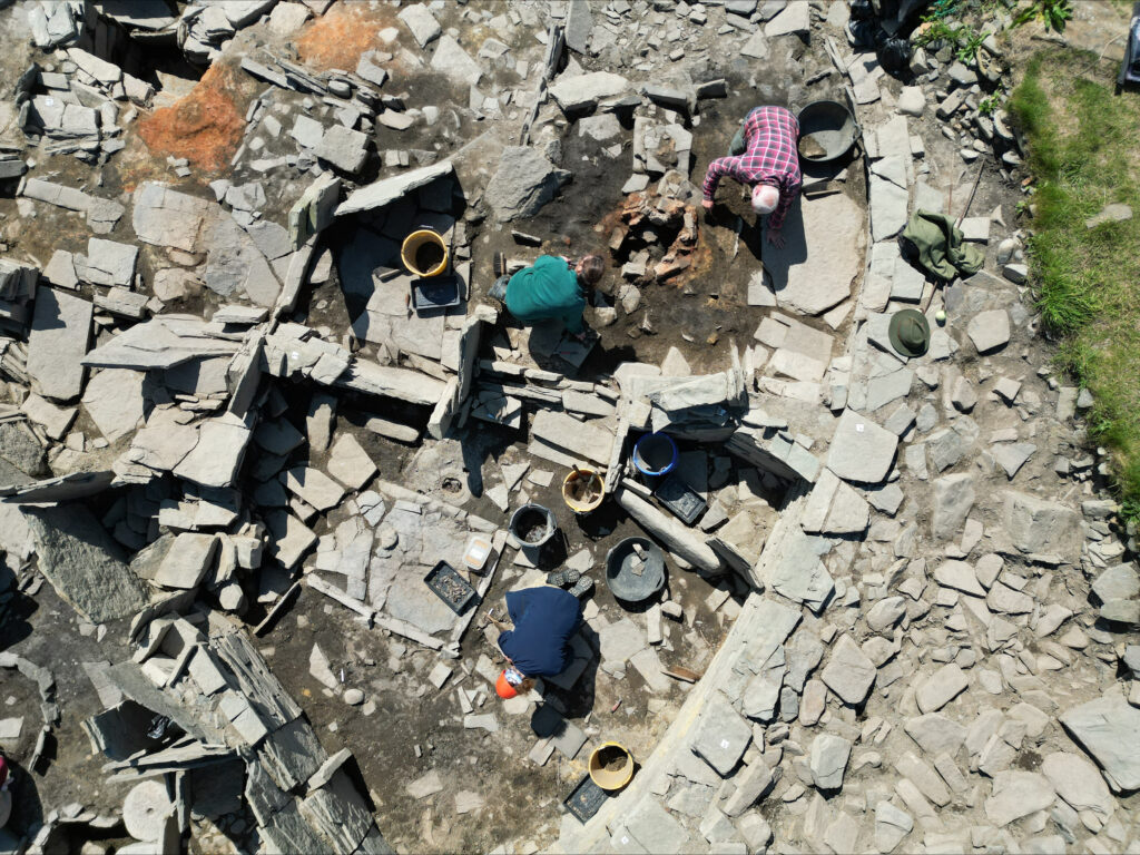 Aerial view of people digging in a trench with a lot of stones