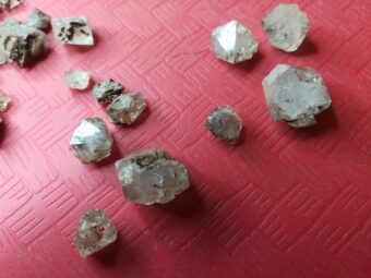 Photo of pieces of rock crystal on a red table