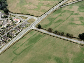 Aerial photo of a huge cropmark site stretching across two fields