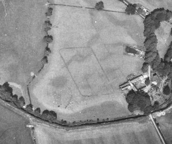 Black and white aerial photo of the rectangular cropmark remains of a roman camp