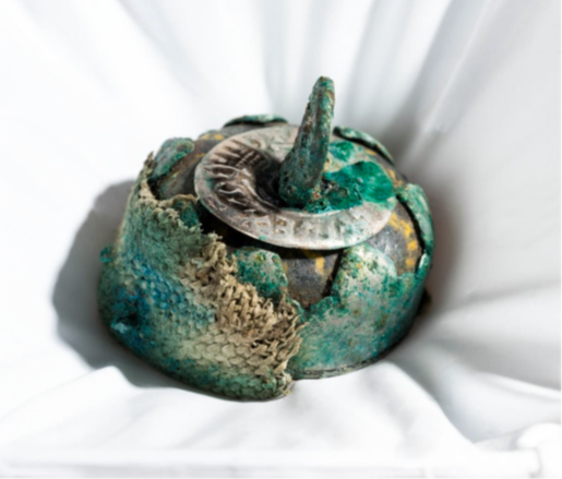 Mineral preserved textile on the metal casing of a composite glass bead pendant from the Galloway Hoard (Image © National Museums Scotland).