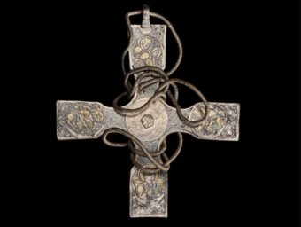 Photo of a decorated metal cross with a wire chain