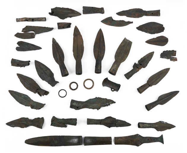 Photo of a collection of bronze weaponry, mostly speak heads, from a hoard