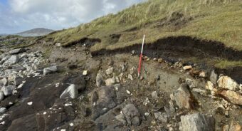 Black, charcoal-rich, peaty deposit below the turf on the eroding coast