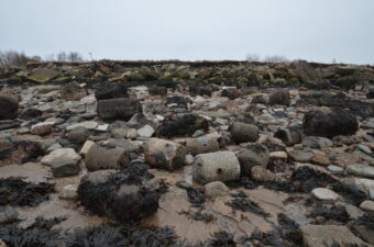 Beach covered with demolition rubble