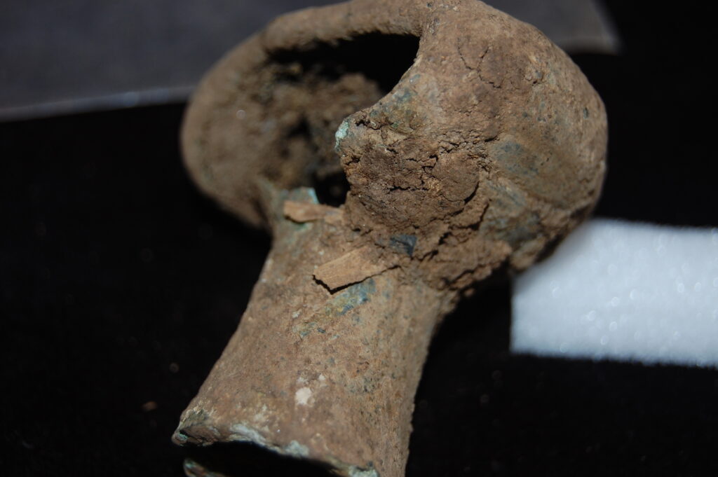 A broken, bronze spearbutt