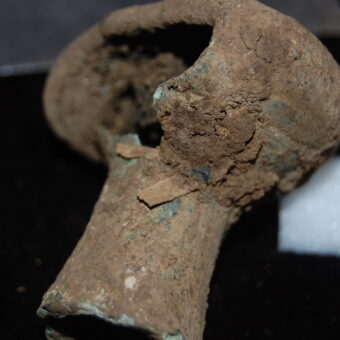 A broken, bronze spearbutt